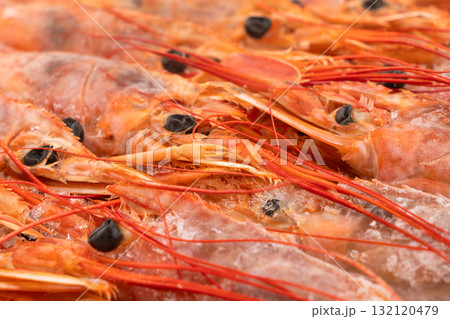 Raw frozen shrimp background. Pile of frozen shrimps. Close-up of frozen shrimps. A lot of royal shrimp macro shot. Red giant argentine shrimp texture background. Large tiger shrimp Raw frozen shrimp background. Pile of frozen shrimps. Close-up of frozen shrimps. A lot of royal shrimp macro shot. Red giant argentine shrimp texture background. Large tiger shrimp 132120479