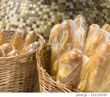 Buns in wicker basket. Composition with bread and rolls Buns in wicker basket. Composition with bread and rolls 132120587