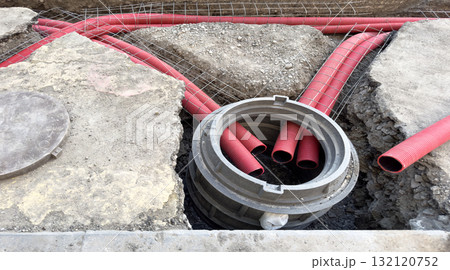Installation of a sewage plastic pipe during the construction. Street reconstruction site with plastic sewage pipes. Building construction site with engineering pipeline drainage technology Installation of a sewage plastic pipe during the construction. Street reconstruction site with plastic sewage pipes. Building construction site with engineering pipeline drainage technology 132120752