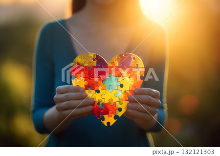 International autism day concept. Woman holding heart shape symbol. Generative AI International autism day concept. Woman holding heart shape symbol. Generative AI 132121303