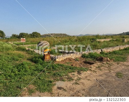 Sirkap round stupa view in Taxila Pakistan showcasing ancient Buddhist architecture and Gandhara heritage through stone ruins and devotion Sirkap round stupa view in Taxila Pakistan showcasing ancient Buddhist architecture and Gandhara heritage through stone ruins and devotion 132122303