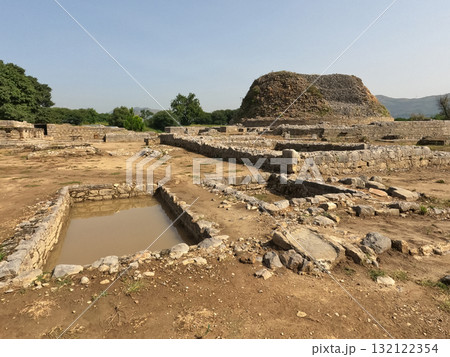 Buddhist ruins of Dharmarajika Stupa with pond and small stupas in Taxila Buddhist ruins of Dharmarajika Stupa with pond and small stupas in Taxila 132122354