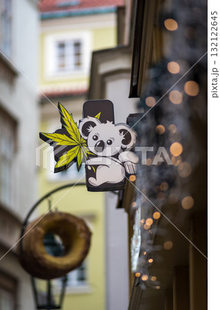 A whimsical koala sign with a cannabis leaf on a narrow street in Old town of Prague, Czech Republic 132122645