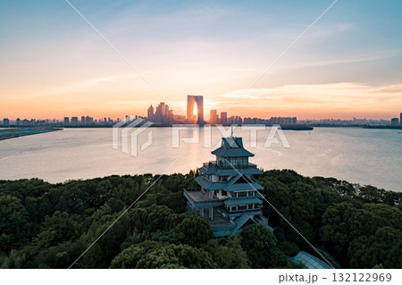 City skyline at sunset with historical architecture and vibrant colors over water City skyline at sunset with historical architecture and vibrant colors over water 132122969