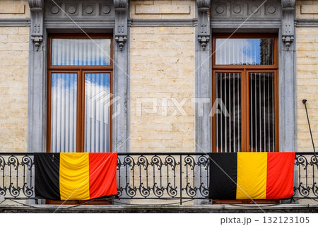Belgian flags draped over the railing of decorative iron balcony in Brussels, Belgium Belgian flags draped over the railing of decorative iron balcony in Brussels, Belgium 132123105