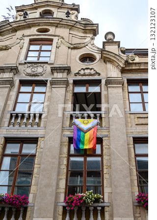Progressive rainbow pride flag hanging from the balcony of an old building in historic city center of Brussels, Belgium Progressive rainbow pride flag hanging from the balcony of an old building in historic city center of Brussels, Belgium 132123107