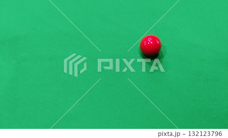 A single red snooker ball resting on a green baize snooker table surface A single red snooker ball resting on a green baize snooker table surface 132123796