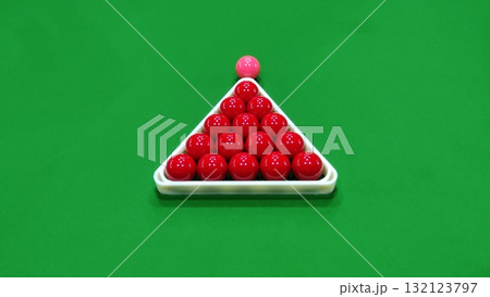 A snooker ball set with red balls and a pink ball on a green background table A snooker ball set with red balls and a pink ball on a green background table 132123797