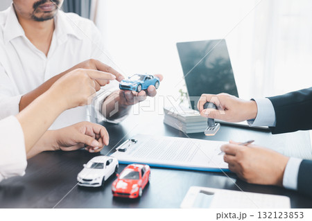 Businessman stamping approved contract for car loan agreement, concept of finance approval, vehicle purchase, leasing, or insurance, symbol of trust, validation, professional deal. approved contract. Businessman stamping approved contract for car loan agreement, concept of finance approval, vehicle purchase, leasing, or insurance, symbol of trust, validation, professional deal. approved contract. 132123853