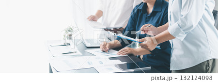 Panorama of corporate teamwork with people discussing financial reports, pointing at charts, planning business strategy, analyzing data and collaborating in office meeting for professional success. 132124098