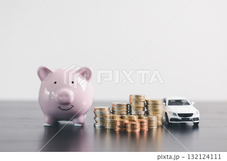 Pink piggy bank with stacked coins beside a white car model, representing savings, car loan, finance, investment, wealth management, insurance and money planning on clean minimal background. 132124111