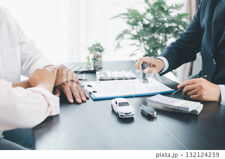 Businessman stamping approved contract for car loan agreement, concept of finance approval, vehicle purchase, leasing, or insurance, symbol of trust, validation, professional deal. approved contract. Businessman stamping approved contract for car loan agreement, concept of finance approval, vehicle purchase, leasing, or insurance, symbol of trust, validation, professional deal. approved contract. 132124239