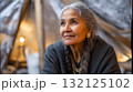 Indigenous elder telling stories inside a warm tent, frost on the outside wall. Life in permafrost conditions, climate change problems on the planet. Global warming 132125102