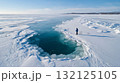 Ice fisherman pulling net from hole in thick frozen lake. Life in permafrost conditions, climate change problems on the planet. Global warming 132125105