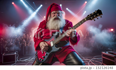 Rock 'n' Roll Santa Claus plays electric guitar on stage during a concert. A unique New Year's celebration. Rock 'n' Roll Santa Claus plays electric guitar on stage during a concert. A unique New Year's celebration. 132126148