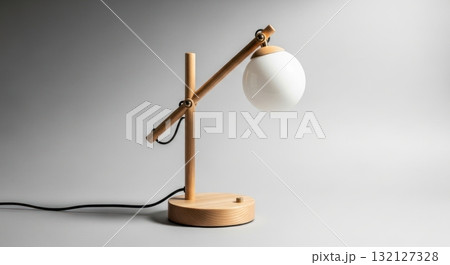 Minimalist wooden desk lamp with spherical white glass shade on a clean grey background Minimalist wooden desk lamp with spherical white glass shade on a clean grey background 132127328