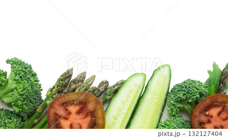 tasty frame of green vegetables broccoli, arugula, cucumber, asparagus, tomato and garlic on a white background tasty frame of green vegetables broccoli, arugula, cucumber, asparagus, tomato and garlic on a white background 132127404