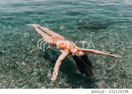 Woman Swimming Ocean Beach Summer - Relaxing in clear blue water on a sunny day at the beach. Woman Swimming Ocean Beach Summer - Relaxing in clear blue water on a sunny day at the beach. 132128196