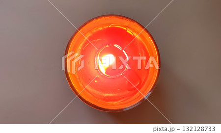 Warm flame in glass candle jar on cold winter day. 132128733