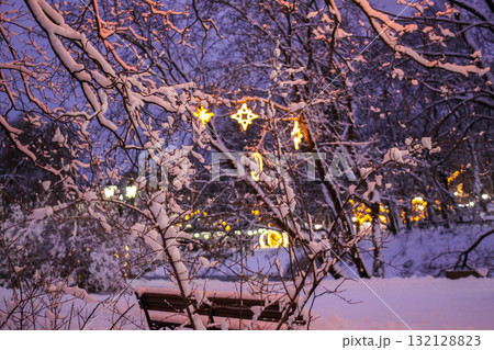 Festive holiday lanterns in snow-covered Riga park. Festive holiday lanterns in snow-covered Riga park. 132128823