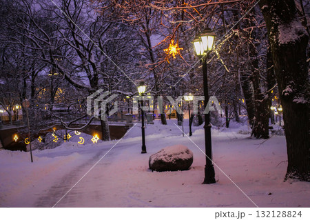 Festive holiday lanterns in snow-covered Riga park. 132128824
