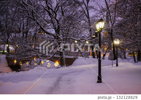 Snowy city park in Riga glowing with festive illumination. Snowy city park in Riga glowing with festive illumination. 132128829