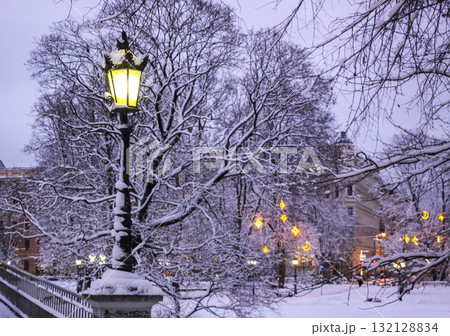 Urban lanterns in snow-covered Riga park. 132128834