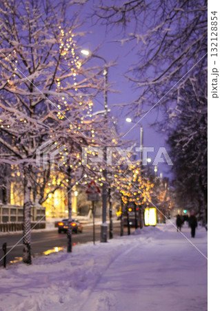 Snow-covered street with festive lights in Riga, Latvia. 132128854