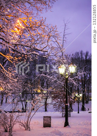 Snow-covered street with festive lights in Riga, Latvia. Snow-covered street with festive lights in Riga, Latvia. 132128855
