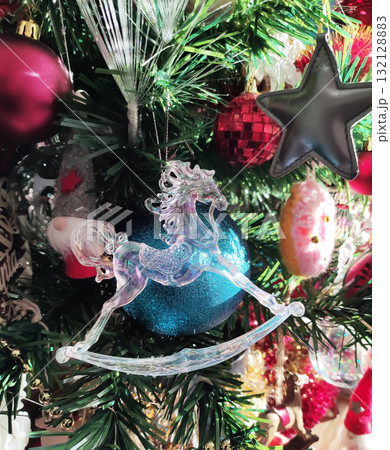 Shining baubles and glitter decor on holiday tree close-up. 132128883