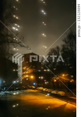 Twinkling fairy lights on window creating warm holiday atmosphere. 132128894