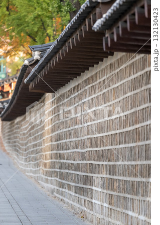 Deoksugung Stonewall Walkway with beautiful autumn foliage. It is the pedestrian footpath that runs next to Deoksugung Palace in Seoul, South Korea 132130423