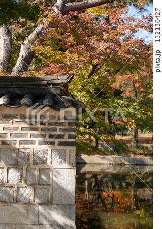 Korean traditional wall with pond and beautiful autumn foliage in the background Korean traditional wall with pond and beautiful autumn foliage in the background 132130427