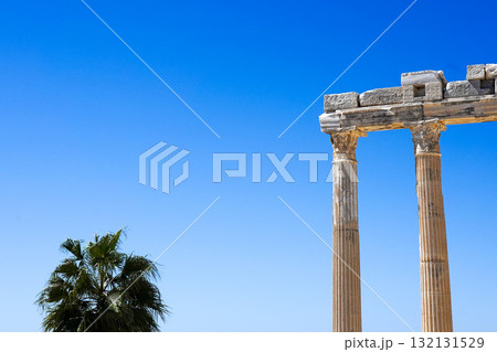 A Stunning View of Ancient Columns Against a Clear Blue Sky, Highlighting the Beauty of Historical Architecture and Nature's Harmony A Stunning View of Ancient Columns Against a Clear Blue Sky, Highlighting the Beauty of Historical Architecture and Nature's Harmony 132131529