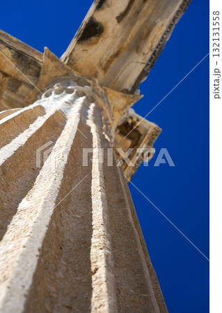 An Architectural Marvel: Capturing the Majestic Details of an Ancient Column Set Against a Clear Blue Sky 132131558