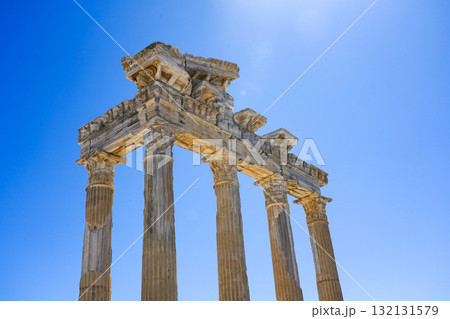 Ancient Architectural Marvel with Tall Columns Against a Clear Blue Sky Highlighting Historical Significance and Cultural Heritage from a Time Long Past Ancient Architectural Marvel with Tall Columns Against a Clear Blue Sky Highlighting Historical Significance and Cultural Heritage from a Time Long Past 132131579