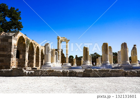 Exploring Ancient Ruins and Well-Preserved Columns Under a Clear Blue Sky in a Historic Archaeological Site Exploring Ancient Ruins and Well-Preserved Columns Under a Clear Blue Sky in a Historic Archaeological Site 132131601