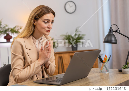 Businesswoman folds hands in prayer laptop looks up hopes for client order or project approval big Businesswoman folds hands in prayer laptop looks up hopes for client order or project approval big 132131648