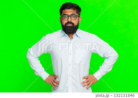 Indian man clenching jaw angry with hands on hips showing rage frustration emotional breakdown Indian man clenching jaw angry with hands on hips showing rage frustration emotional breakdown 132131846