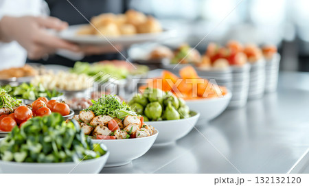 Fresh salads and colorful dishes arranged in buffet setting 132132120