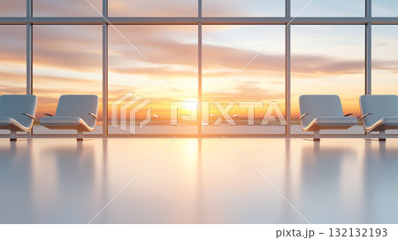 Spacious airport lounge with comfortable seating and sunset view 132132193