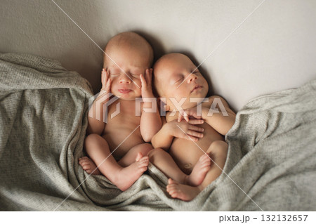 twins, brother and sister were born. A newborn baby is wrapped in diapers with a wool cap in a basket. Swaddling, maternity hospital, family, ivf, life planning, parenting. A mother's love for her twins, brother and sister were born. A newborn baby is wrapped in diapers with a wool cap in a basket. Swaddling, maternity hospital, family, ivf, life planning, parenting. A mother's love for her 132132657