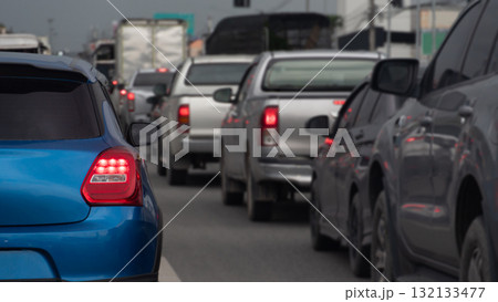 Rear side of blue car with turn on brake light. Traffic jam in the city environment time before rainy. under dark sky. 132133477