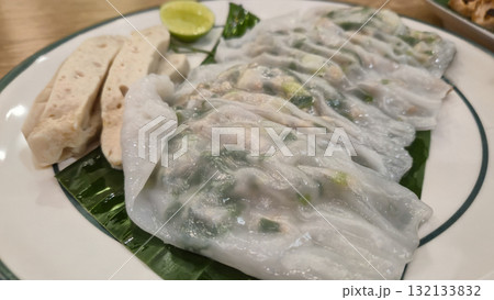 Vietnamese steamed rice rolls with herbs and dipping sauce on plate 132133832