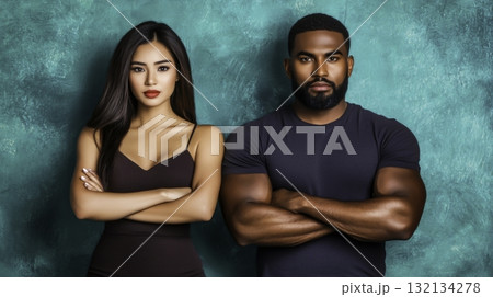 Diverse Couple Posing Confidently Against Vibrant Teal Background Diverse Couple Posing Confidently Against Vibrant Teal Background 132134278