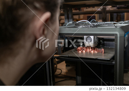 female engineer is engaged in setting up and controlling a 3D printer. female engineer is engaged in setting up and controlling a 3D printer. 132134809