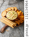 creamy, punchy egg dip that really tastes just like a deviled egg with bread close-up in a plate. Vertical 132134964
