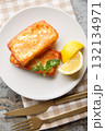 Authentic Greek Fried Cheese Saganaki close-up in a plate on the table. Vertical top view 132134971