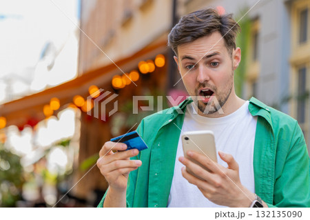 Shocked angry man trying to pay online shopping with smartphone blocked credit card lack of money Shocked angry man trying to pay online shopping with smartphone blocked credit card lack of money 132135090