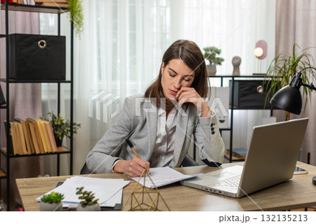 Business busy woman thinking about an important creative project work laptop decision at home office Business busy woman thinking about an important creative project work laptop decision at home office 132135213